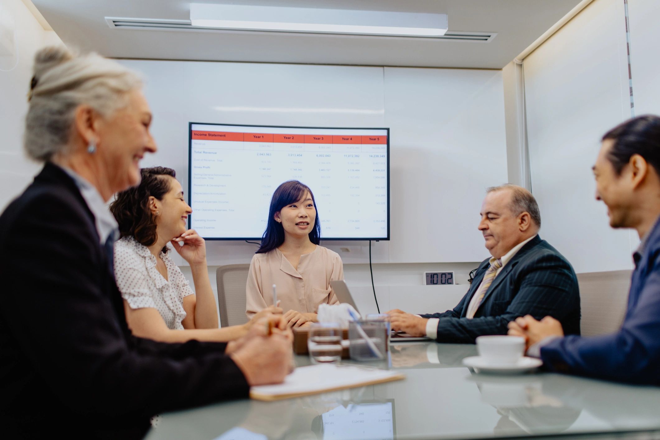 Advisors in a private client meeting reviewing investment materials