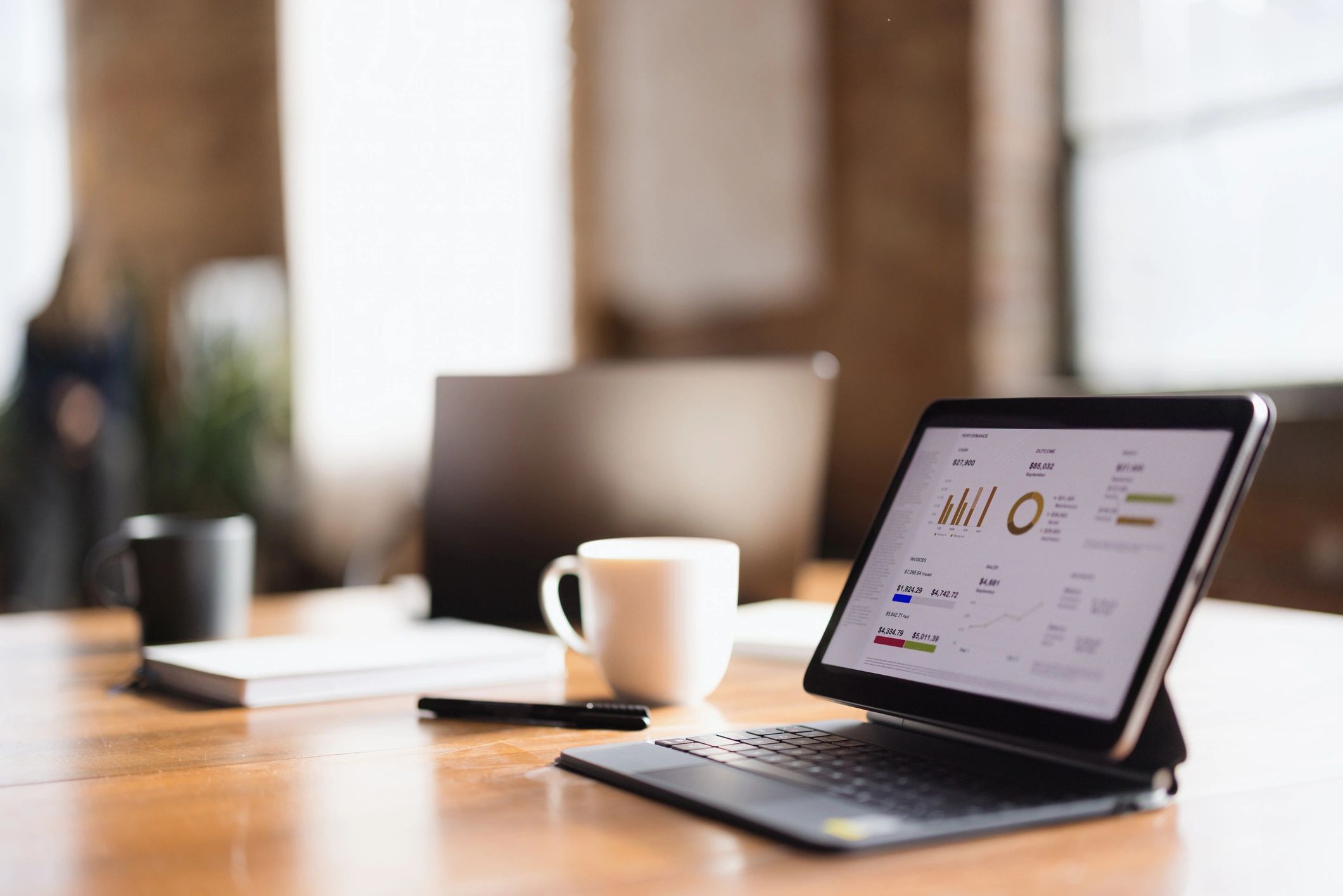 Financial analysis on tablet and desk