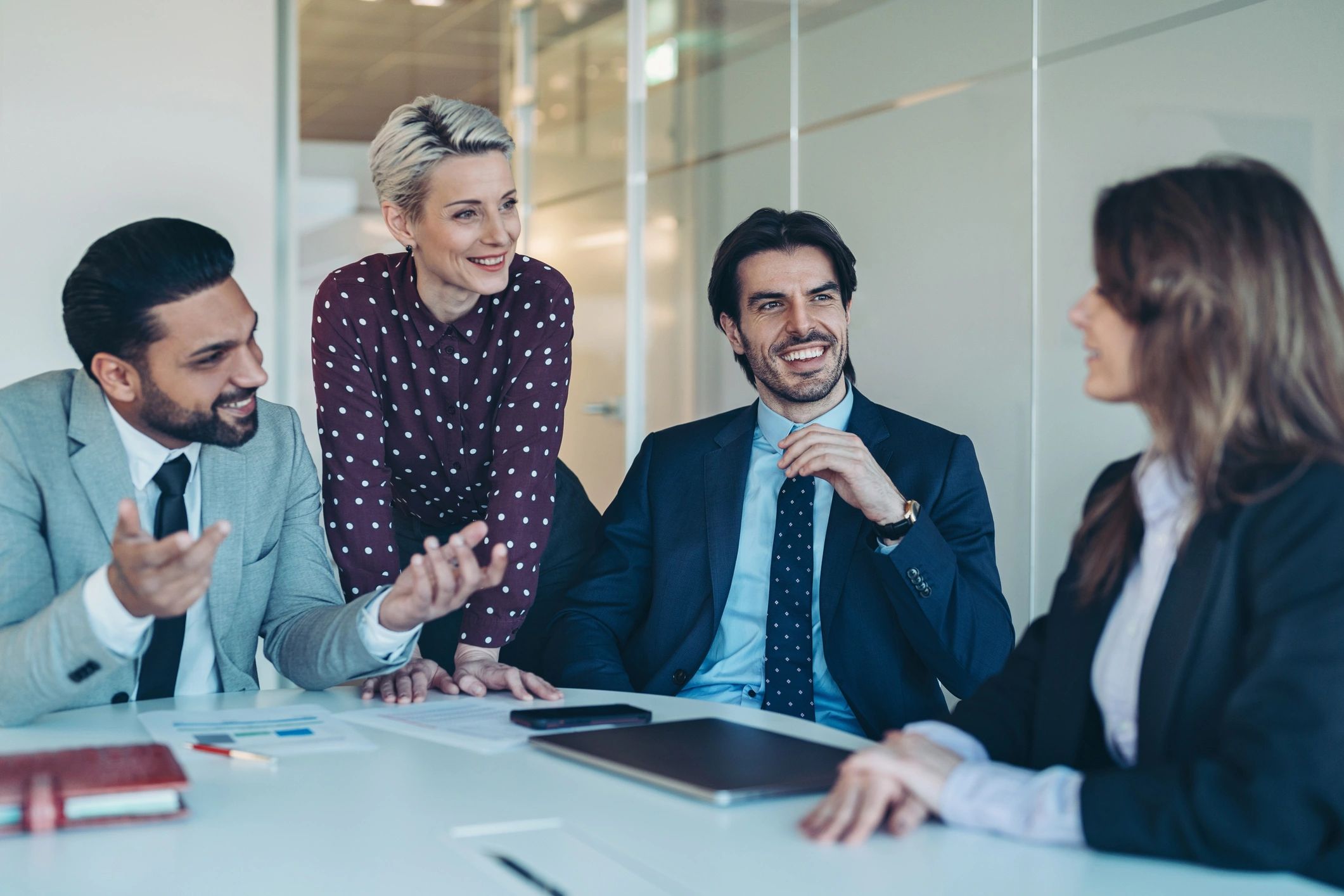 Investment professionals in a meeting reviewing a proposal