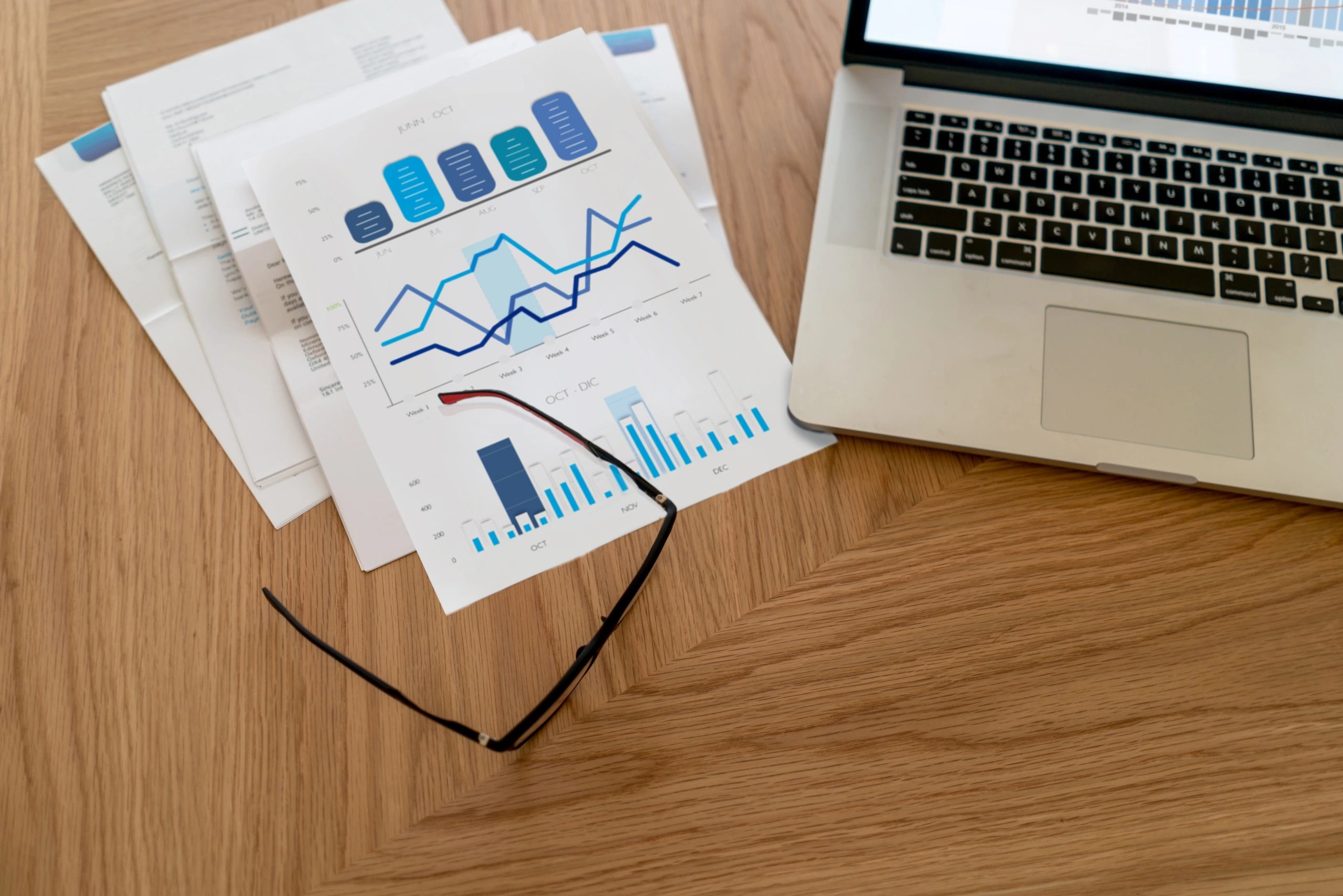 Financial documents and laptop representing underwriting and analysis